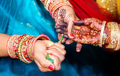 Midsection of couple holding hands