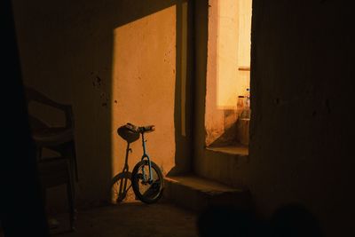 Bicycle by window in building