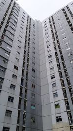 Low angle view of modern buildings in city against sky