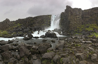 Scenic view of waterfall against rocks