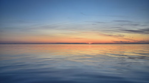 Scenic view of sea against romantic sky at sunset