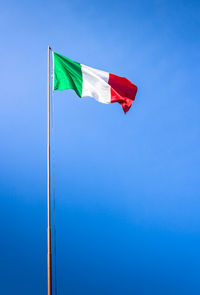 Low angle view of italian flag against blue sky during sunny day