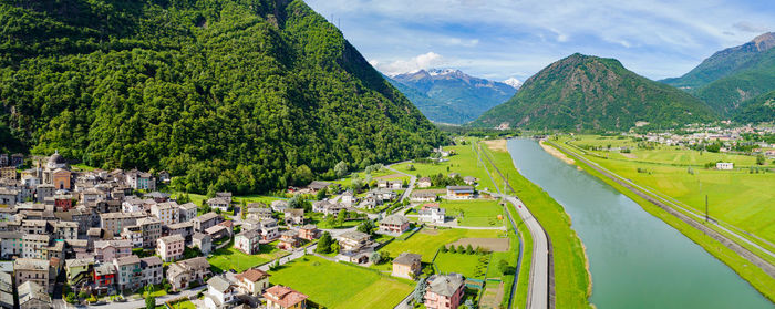 High angle view of city and mountains against sky