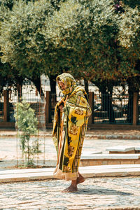Rear view of person standing against trees
