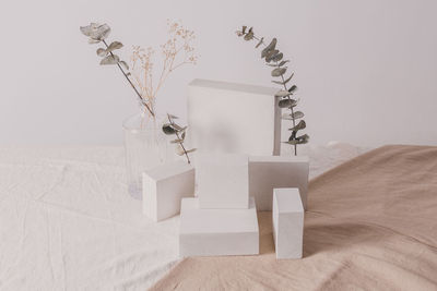 White vase on table against wall at home