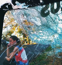 Close-up of young woman using mobile phone outdoors