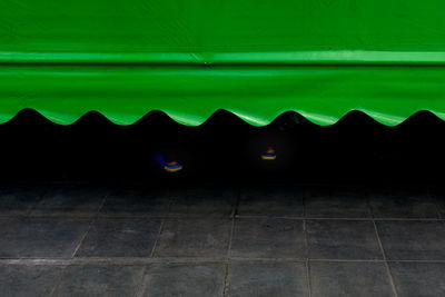 Illuminated wall by building against sky