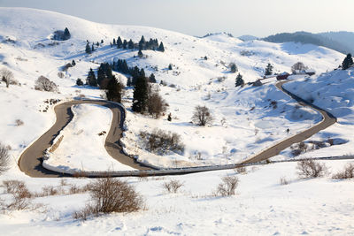 Scenic view of snow covered mountains against sky