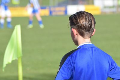 Rear view of player standing on field