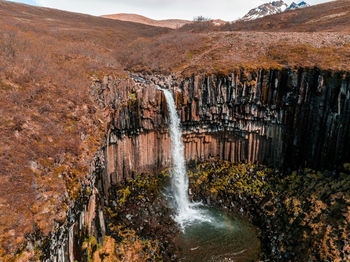 Aerial view of the svartifoss waterfall surrounded by basalt columns