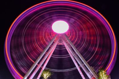 Low angle view of ferris wheel against sky at night