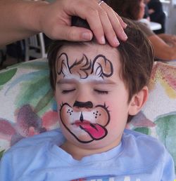 Close-up portrait of boy wearing face paint