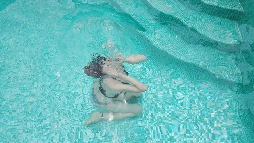 Low section of person in swimming pool