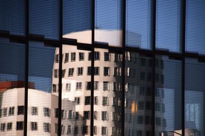 Low angle view of modern glass building in city