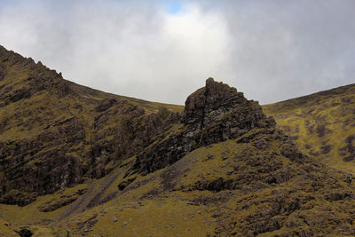 Low angle view of rocky mountain against sky