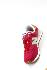 Close-up of toy shoes over white background