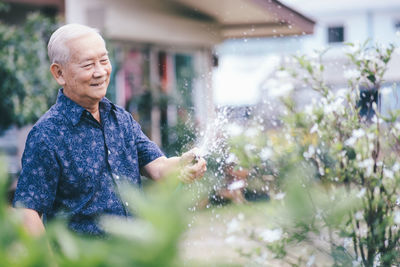 Full length of man looking at plants