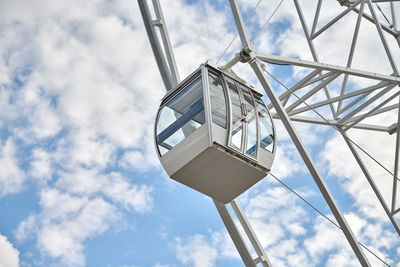 Observation wheel cabin close up blue sky background. passenger car of ferris wheel, amusement park