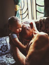 Grandfather playing with grandson at home