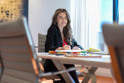 Portrait of young businesswoman working in office