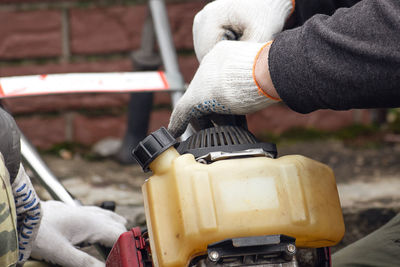 Close-up of man working on metal