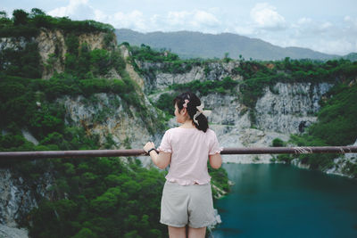 Rear view of woman looking at mountains