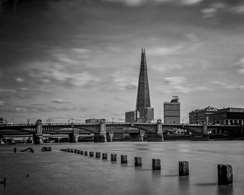 Bridge over river with buildings in background