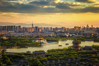 High angle view of buildings in city during sunset