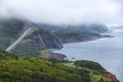 High angle view of sea and mountains against sky