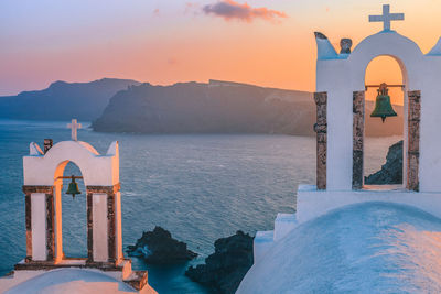 Scenic view of sea by building against sky during sunset