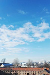 Low angle view of buildings against blue sky