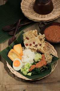 Nasi pecel.traditional javanese rice dish of steamed rice with vegetable salad,peanut sauce dressing