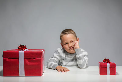 Portrait of smiling boy against red background