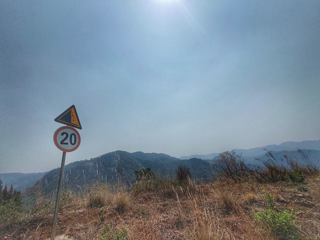 ROAD SIGNS ON FIELD AGAINST SKY