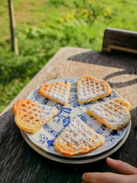 Heart shape sweet food in plate on table