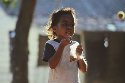 Boy eating food outdoors