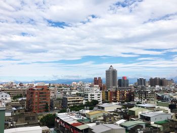 High angle view of buildings in city against sky