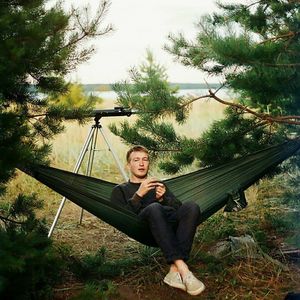 Portrait of young man relaxing on hammock