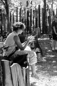 Mother and daughter against trees