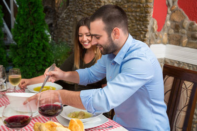 Young couple with drink on table