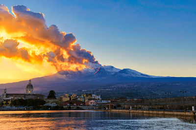 Panorama of the ionian coast with the eruption of etna