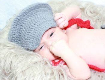 Portrait of cute baby girl lying on bed