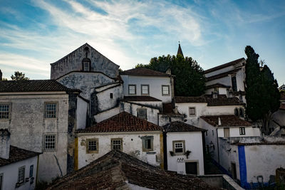 Houses in town against sky