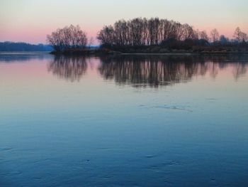 Scenic view of lake at sunset