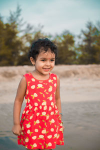 Portrait of baby girl standing at beach