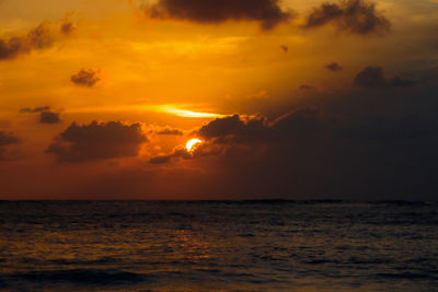 Scenic view of sea against orange sky