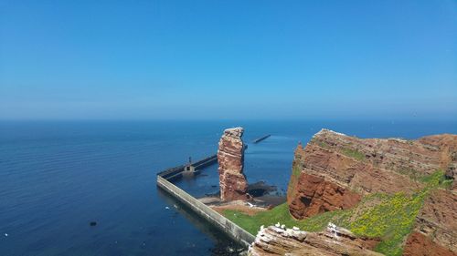 High angle view of sea against clear blue sky