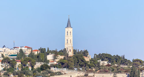 Tower of buildings against clear blue sky