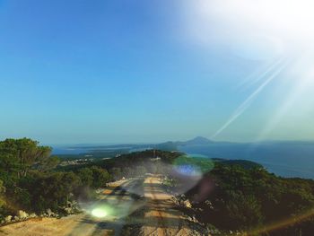 Aerial view of landscape against blue sky