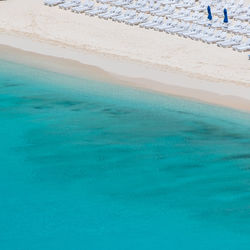 Empty beach chairs on beach in the caribbean 